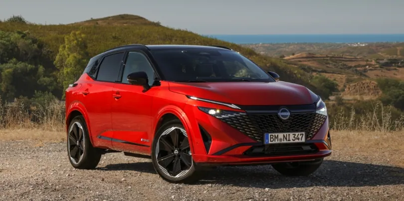 New refreshed Qashqai 2024 in fuji sunset color parked beside the road in Faro, Portugal